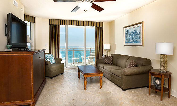 King bed and three queen beds in a fully equipped condo with oceanfront views.